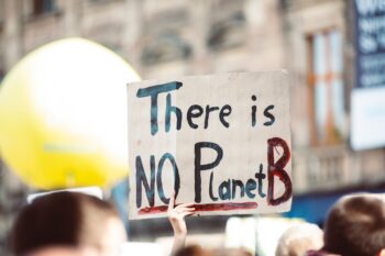 image depicting climate march focused on a sign that says There Is No Planet B